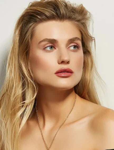 Portrait of a woman with long blonde hair and naturally defined lips