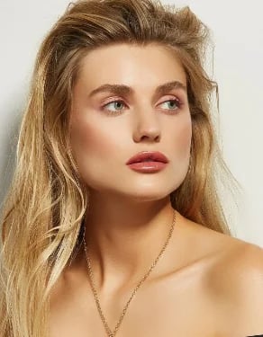 Woman with long blonde hair, three-quarter view showing natural lip proportions