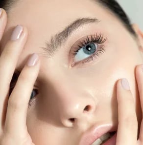 Close-up of a woman's eye and cheek showing smooth, even skin texture