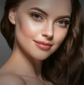 Close-up portrait of a woman with a refined, natural-looking nasal tip