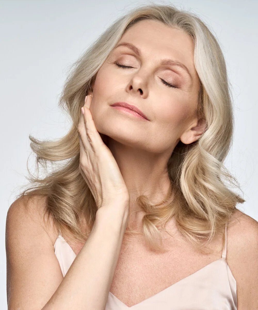 Close view of a woman's temple and hairline, where a facelift incision route begins